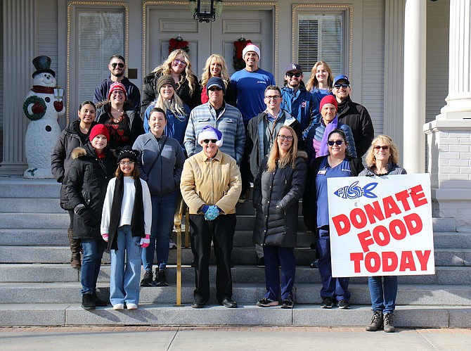 Volunteers show their holiday spirit on the steps of the Governor’s Mansion to receive donations from local residents Dec. 8, 2023 during the Share Your Christmas Food Drive benefiting Friends in Service Helping and the Ron Wood Family Resource Center.