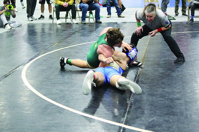 Battle Mountain’s Wyatt Madalena attempts to turn Reed’s Kalayo Donald on his back in a 157-pound match at the Cody Louk Invitational in Winnemucca. Madalena finished second in the weight class.