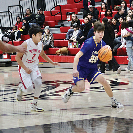 Lowry's Matthew Casalez drives to the basket for a shot in the Buckaroos' 61-25 win over Pershing County on Saturday in Lovelock.