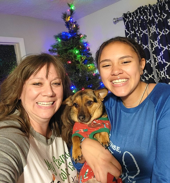 Marty, left, and Emilee Elzy with Buttercup on Christmas Eve of 2022.