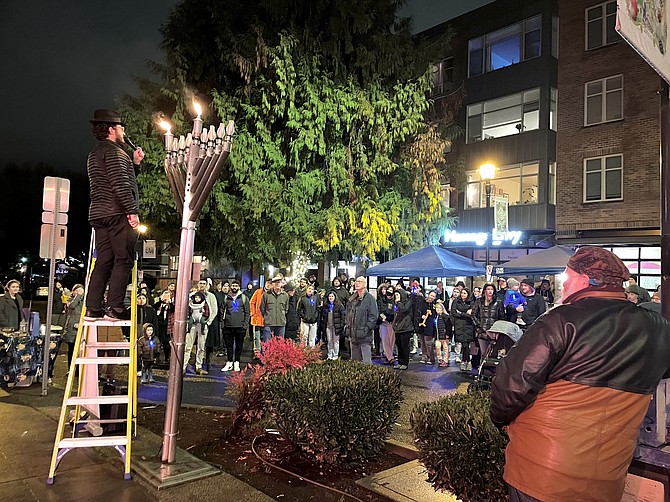 Rabbi Shnai Levitin lights the candle on the first night of Chanukah, Dec. 7.