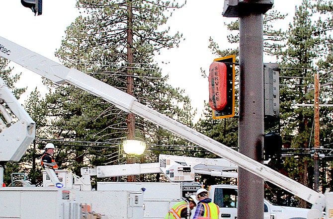 Workers install a traffic signal in late September at Warrior Way and Highway 50.