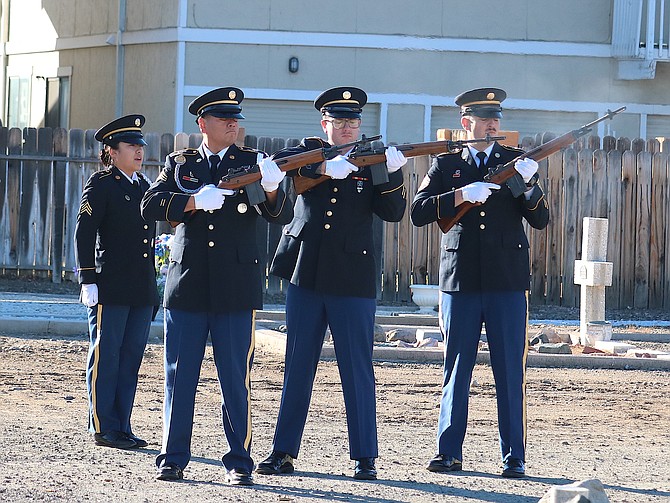 Members of the Nevada National Guard fire a three-volley salute at the Garden Cemetery on Saturday.