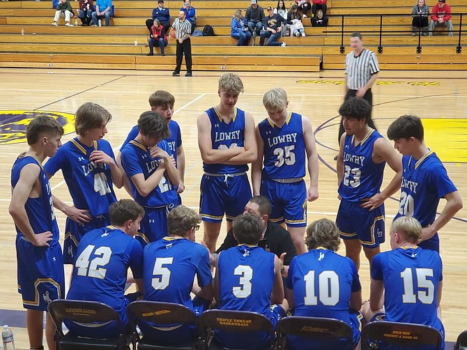 Lowry boys coach Jesse Zamudio talks to the team during a break in the action during a game at the Super 8 Classic in Susanville, Calif.