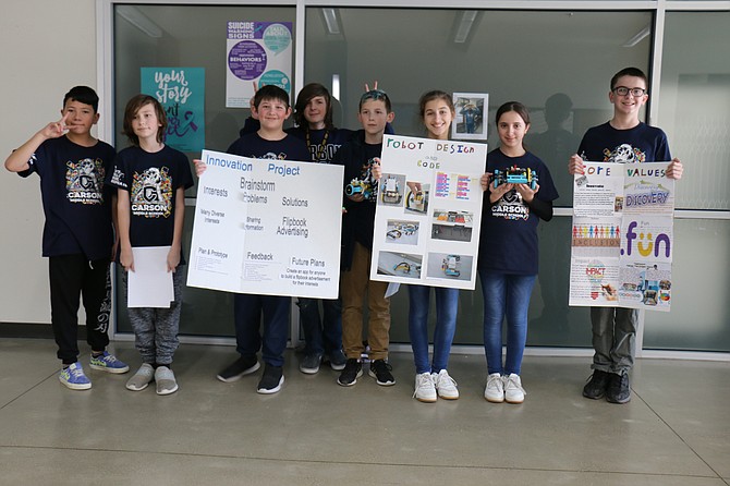 Carson Middle School’s LEGO League team, from left, Andrik Topete, 11, Walter White, 11, Cameron King, 11, Johnny Lash, 12, Lucien Roew, 12, Celine Assad, 12, Lorene Assad, 12, and Nolan Smith, 12, demonstrate their robot design at the FIRST LEGO League Qualifier at Eagle Valley Middle School on Dec. 16, 2023.