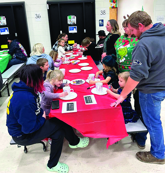 Families gather in the cafeteria for a night of holiday crafts and games for the entire family to enjoy.
