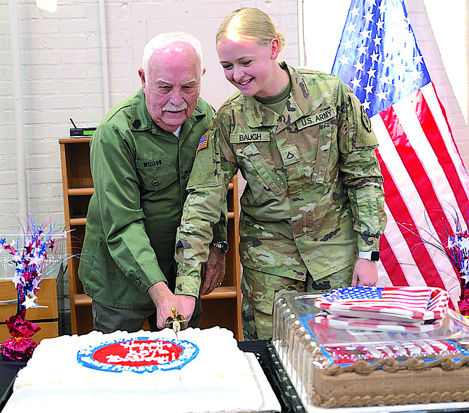 Retired Nevada Army Guard Command Sgt. Maj. Walter Willson, left, and Pfc. Alexis Baugh cut a cake to celebrate the National Guard’s 387th birthday on Dec. 14.