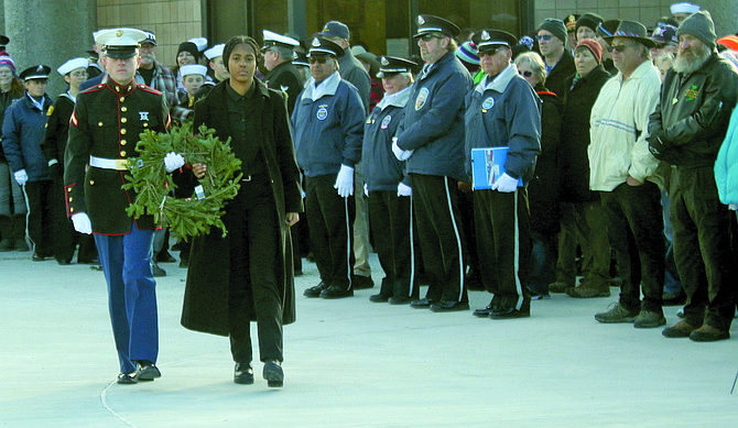 Pfc. Ben Ligier, left, who graduated from the U.S. Marine Corps boot camp three weeks ago, and Fallon Sea Cadet Selah King walk to the USMC flag at the Saturday’s Wreaths Across America program at Fernley.