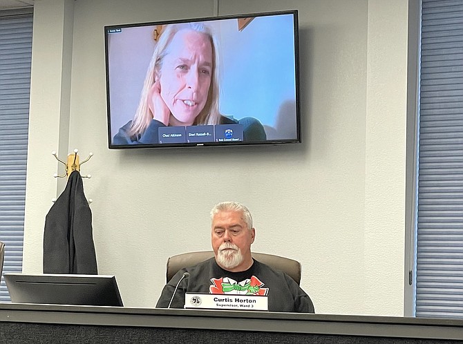 Carson City Supervisor Curtis Horton listens to New Mexico artist Karen Yank on a video monitor during Thursday’s Board of Supervisors meeting.