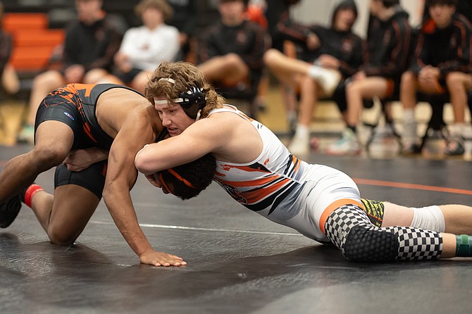 Douglas High senior Aaron Tekansik works the head of his opponent from Fernley Wednesday evening. Tekansik went 2-0 in his two matches with two wins by fall.