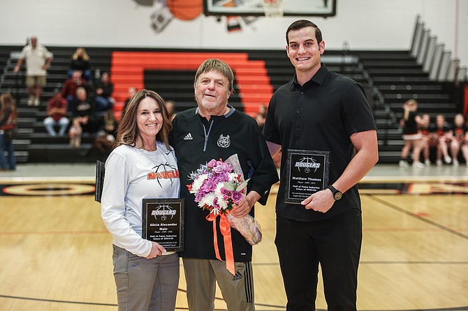Douglas High School basketball Hall of Fame inductees Alicia Main, left, Werner Christen, middle and Matt Thomas, right, pose with their plaques after joining the Tiger basketball Hall of Fame December 8.