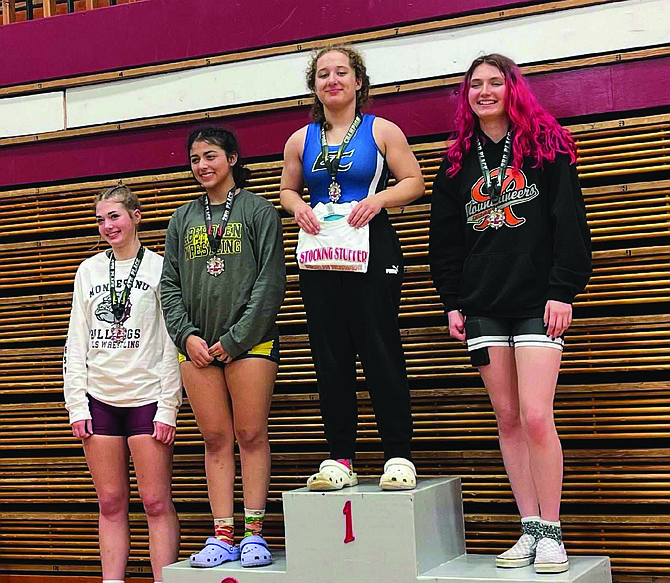 Brooke Ostendorf of Eatonville proudly occupies the podium as the 2023 Grizzly Stocking Stuffer champion in the 140-pound weight class.