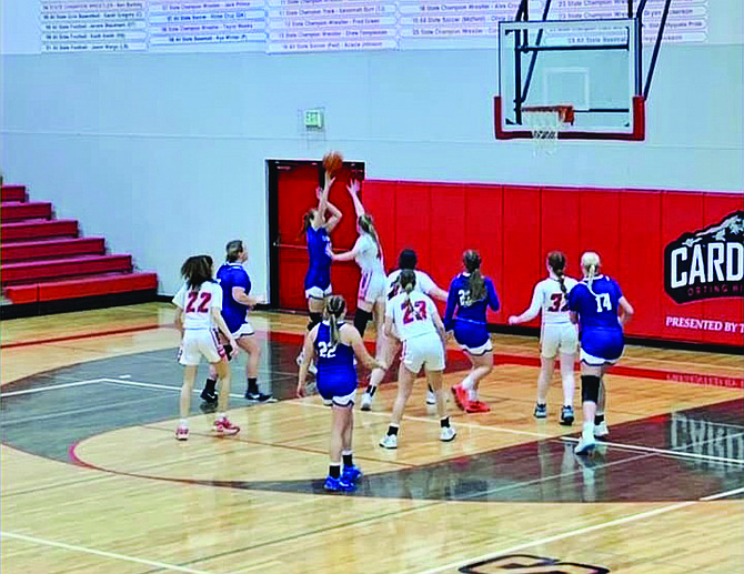 Eatonville's Hailey Hall scores on Orting's Lily Catlett in the Cruisers 55-28 victory over the Cardinals. Hall would dominate in the paint and pull down 14 rebounds in the game.