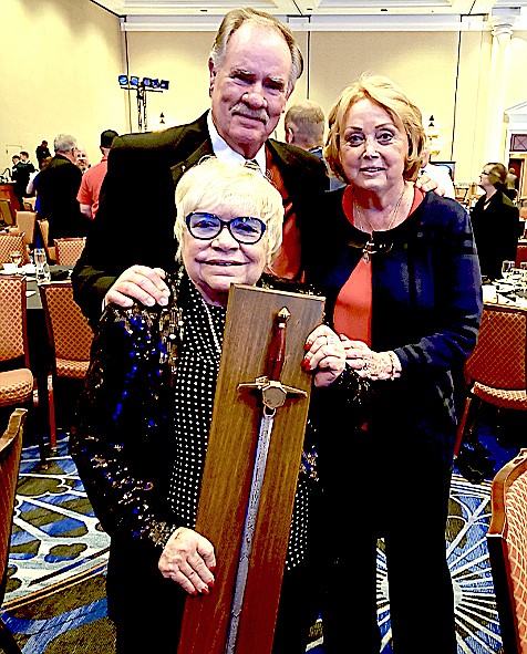 Bobbi Thompson, center, with the International Council of Air Shows Sword of Excellence in Las Vegas.