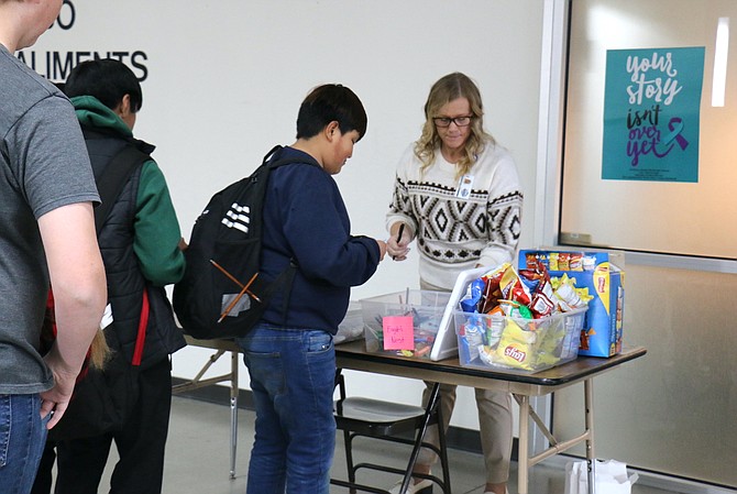 Students at Eagle Valley Middle School line up Dec. 7 to receive prizes they’ve earned for good behavior as part of the school’s Positive Behavioral Interventions and Supports system.