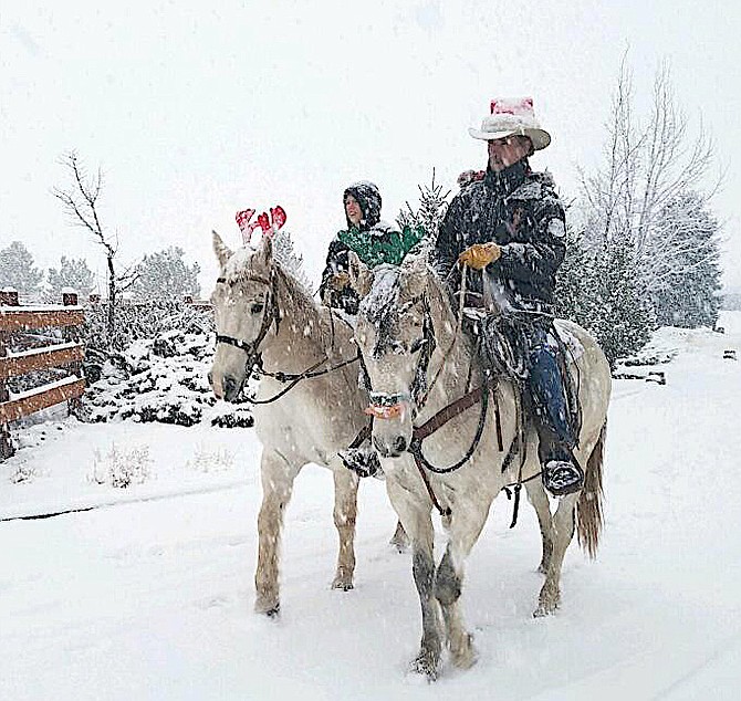 Former Commission Chairman John Engels submitted this photo he took last year of cowboy Steve Cummings riding Pepper with his nephew riding Lobo on the old Kimmerling ranch last winter.