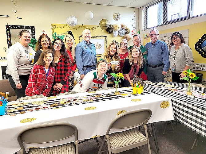 Genoa Volunteer firefighters Rick Myers and Martin Manning with the staff of Jacks Valley Elementary School on Dec. 21.