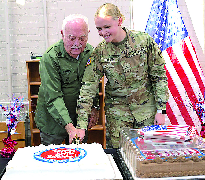 Nevada Guard Photo
Retired Nevada Army Guard Command Sgt. Maj. Walter Willson, left, and Pfc. Alexis Baugh cut a cake to celebrate the National Guard’s 387th birthday on Dec. 14.