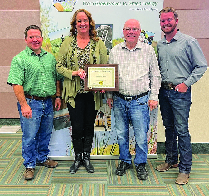 Anne McMillin (public information officer) received recognition for five years of service with Churchill County. From left are Commissioner Justin Heath, McMillin, and Commissioners Bus Scharmann and Wyatt Getto.