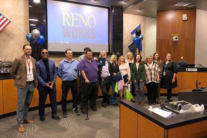 Reno Works graduates pose with Reno city officials and Volunteers of America leaders for a group photo at Reno City Hall on Nov. 14, 2023.