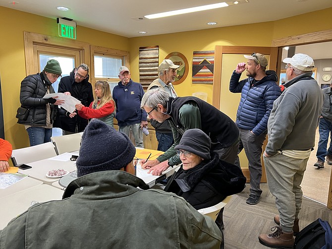 Birders pore over a map at Whit Hall on the River Fork Ranch Preserve before going out to participate in Sunday’s Christmas Bird Count.
