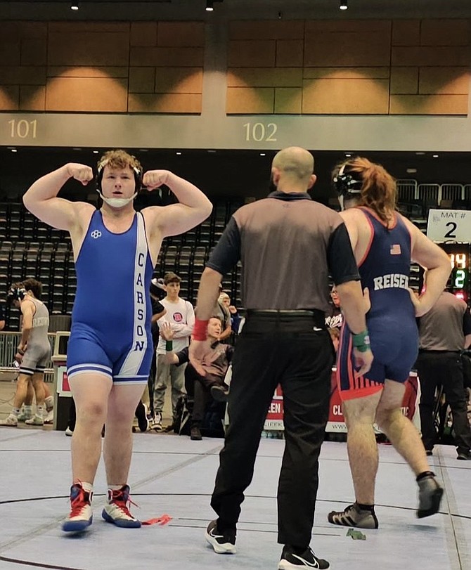 Carson High’s Dominic Porter flexes after winning a match at the Sierra Nevada Classic. Porter won eight matches at the two-day tournament, taking third place in the heavyweight class.