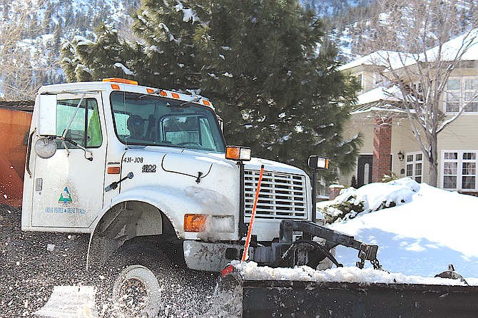 A county snowplow clears Jacks Valley Road during the winter of 2023.
