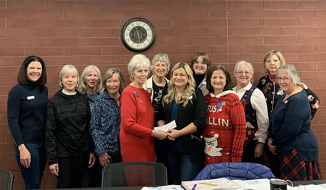 Amanda Johnson receives a scholarship check from the John C. Fremont Chapter of the Daughters of the American Revolution.