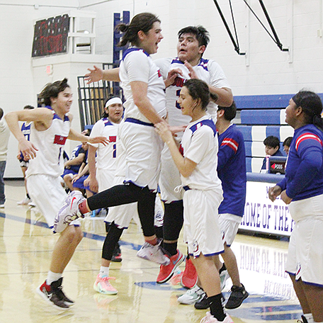 The McDermitt High School boys basketball team celebrate its win over Jackpot on Friday night.