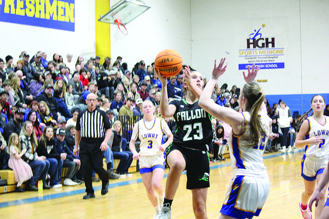 Fallon’s Karlie Simper looks to pass against Lowry during the Greenwave’s first loss of the 3A season on Friday.