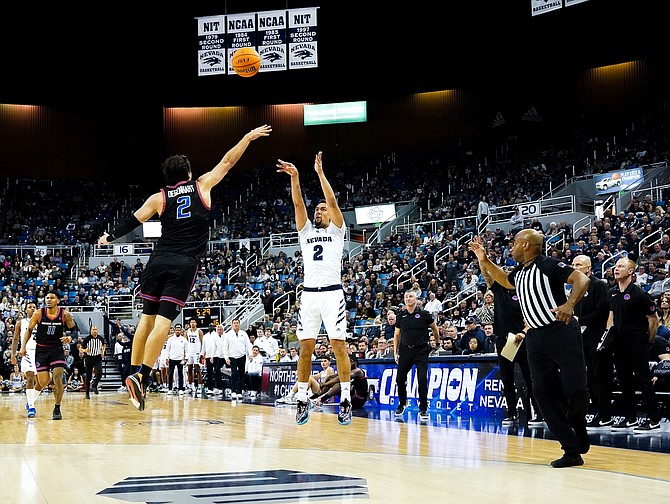 Nevada’s Jarod Lucas launches a 3-pointer over Boise State’s Tyson Degenhart during the Wolf Pack’s loss to the Broncos on Friday.