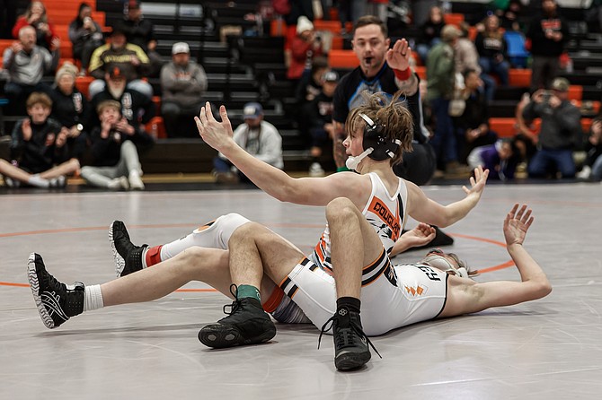 Douglas High’s Gunnar Bleeker puts his hands up in celebration after pinning his opponent in his first-place match at 113 pounds. Bleeker went 3-0 to win his bracket at the Steve Deaton Memorial Tournament.