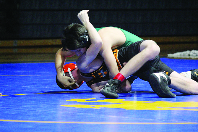 Battle Mountain’s Cruz Jimenez finishes off a pin of Fernley’s Elijah Chappell.