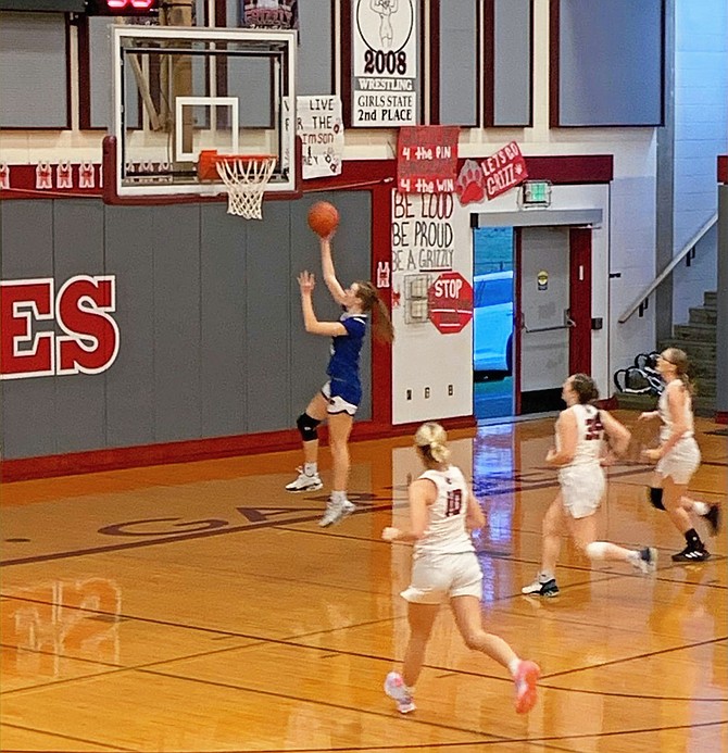 Eatonville's Hailey Hall outruns three Hoquiam defenders and scores two of her career-high 20 points in the Cruisers' 60-16 win over the Grizzlies.