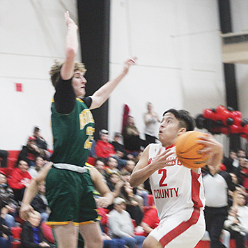 Pershing County's Trenton Rhodes shoots past a Battle Mountain defender.