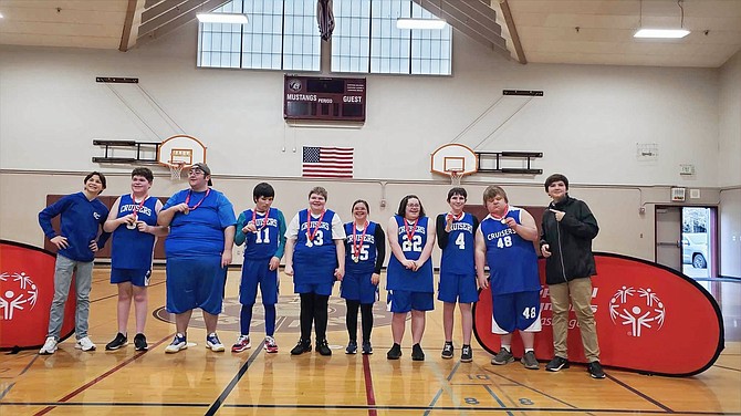 The Eatonville Special Olympics team poses with gold medals after capturing first place at a team skills competition. From left: Coach Sam Kralik, Christian Stacy, Trever Stacy, Jason Pederson, Leah Smiley, Maya Frink, Allison Collins, Ayden Hildebrand, Aaron Schmidt and Coach Cody Jumper.