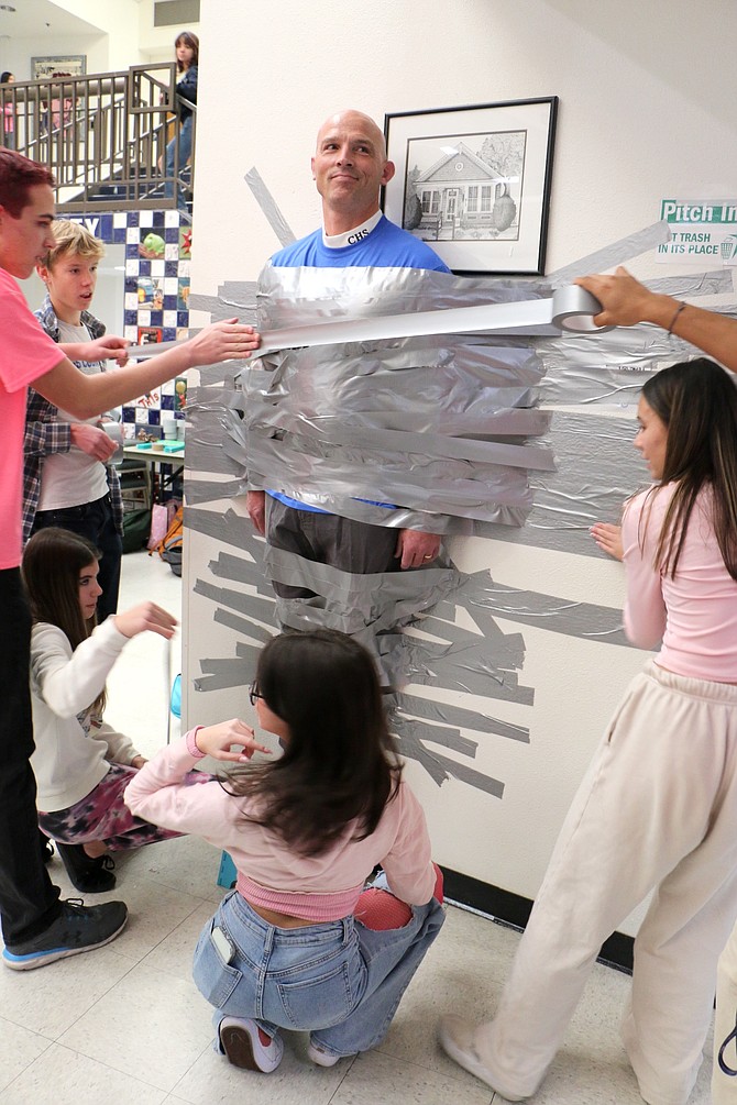 Carson High School Principal Dan Carstens is duct taped to a wall in Senator Square by students for the Special Olympics, the charity designated by Winterfest.
