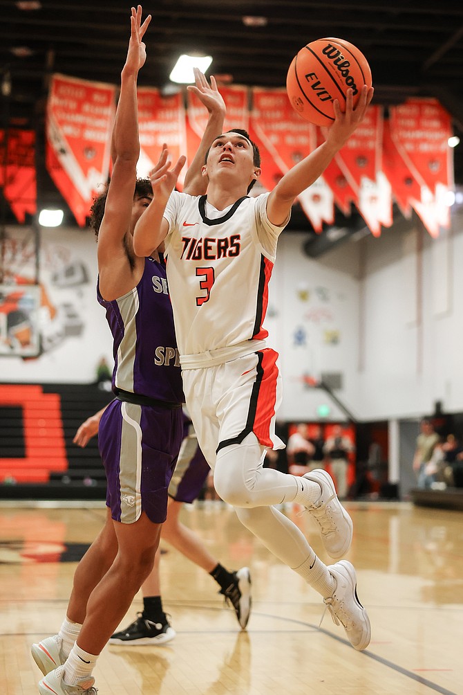 Douglas point guard Caden Thacker goes up for a layup, during the Tigers’ first meeting with Spanish Springs. Douglas fell, 56-38, to the Cougars Friday night in Sparks.