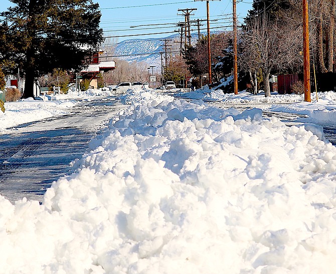 Monday's sunny weather may have helped reduce the berm down the middle of Eighth Street in Minden. The county seat set a record for single day snowfall with 18 inches on top of the 7 inches it received early Sunday morning.
