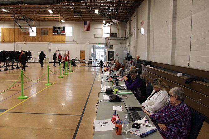 Poll workers sitting inside the Carson City Community Center on Tuesday, election day for the Presidential Preference Primary.