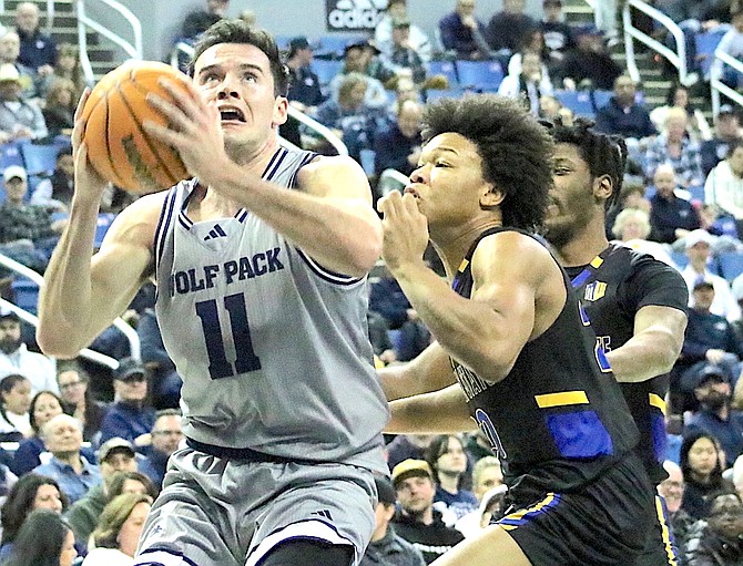 The Wolf Pack’s Nick Davidson (11), shown against San Jose State’s Kellen King, had a career-high 25 points against Utah State.