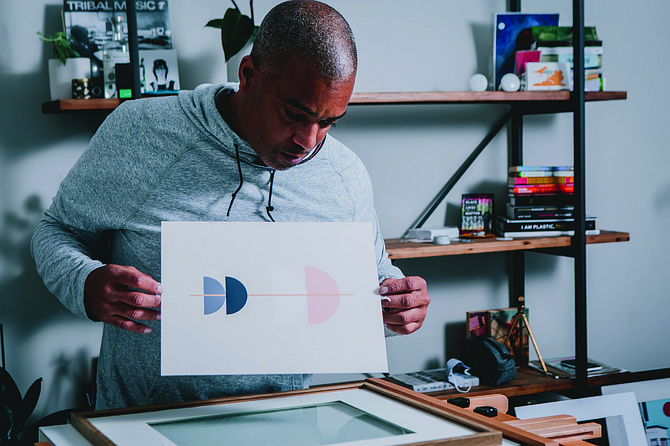 Damon Brown is shown working on a limited-edition print at Creative Lou Studios.