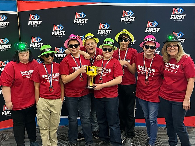From left, Eagle Valley Middle School Coach Kim Tucker, team members Kassandra Mosqueda, Nicholas Budd, Allen Riley, Hunter Budd, Edwin Curiel Leon, McKenna Weber and Coach Becky Ritter celebrate winning the Northern Nevada’s FIRST LEGO League Championship on Jan. 27 at the University of Nevada, Reno with a LEGO trophy.