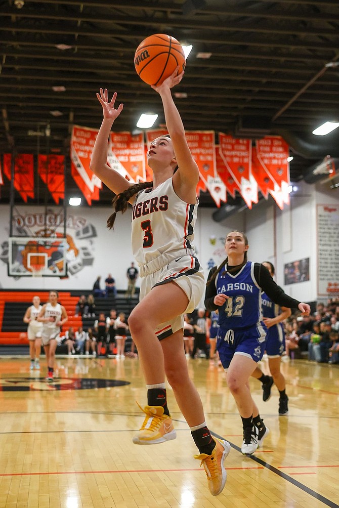 Douglas High senior McKenzie Main goes up for a layup Friday night against Carson. Main had a game-high 19 points as the Tigers beat the Senators, 63-29.