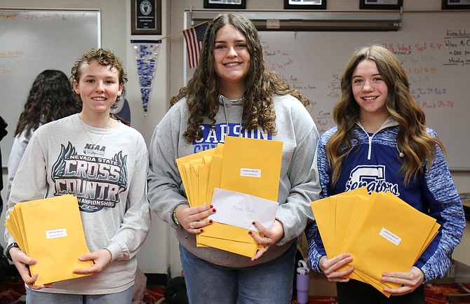 Carson High School junior Eleanor Romeo, sophomore Sadie Brown and sophomore Kate Syndergaard hold the Miracle Minute donation packets gathered from classes Friday to support the family of freshman Lexi Rodriguez, who died Jan. 28 after she was struck by a car at the intersection of North Carson Street and Nye Lane.