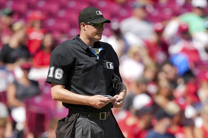 Umpire Clint Vondrak stands on the field during a game between the Washington Nationals and the Cincinnati Reds in 2022.