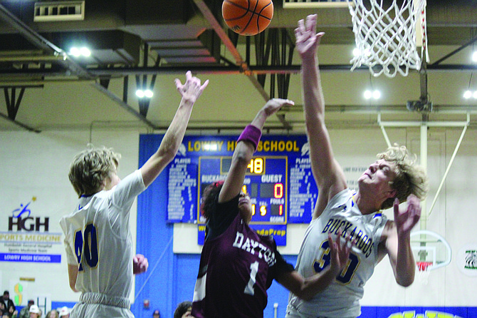 Lowry’s Kayd Garner (40) and Kasyn Garner (30) go up to block a shot during Friday’s 68-44 win over Dayton.