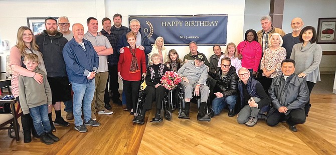 Friends and family of Bill Jameson gather around the World War II veteran at his 100th birthday party Feb. 4.