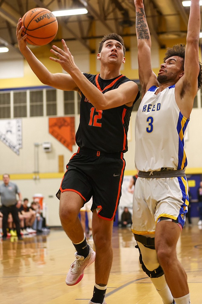 Douglas High senior Reese Torres drives into the lane for a layup Wednesday night, during the Tigers’ Class 4A North regional quarterfinal game at Reed.