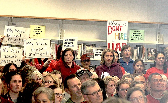 Protesters had signs at Tuesday's Douglas County School Board of Trustees meeting.